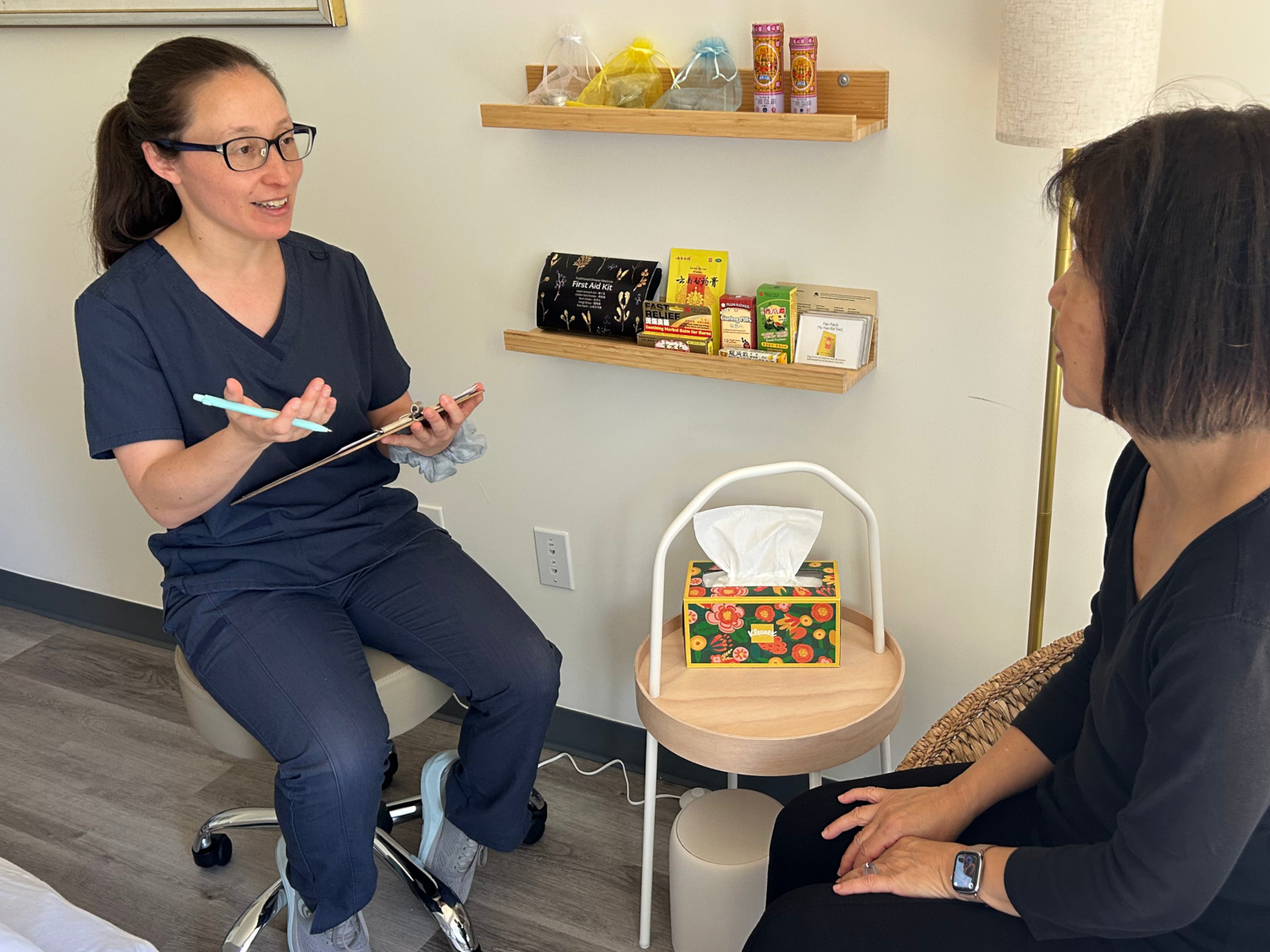 Photo of Dr. Jessica conversing with a patient